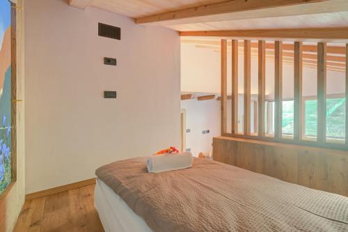 a bedroom with a bed and a large window at Cuore Alpino in Livigno