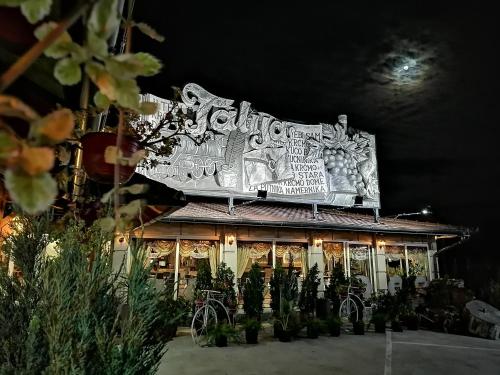 a building with a large sign on top of it at Hotel Talija in Svilajnac