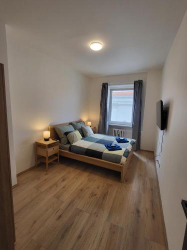a bedroom with a bed and a window at City Center Apartments - Moderna Brno Římské náměstí IV in Brno