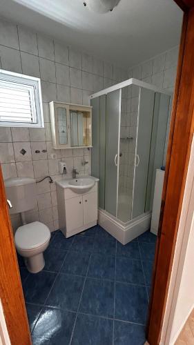 a bathroom with a toilet and a sink at Apartments Renko in Stari Grad