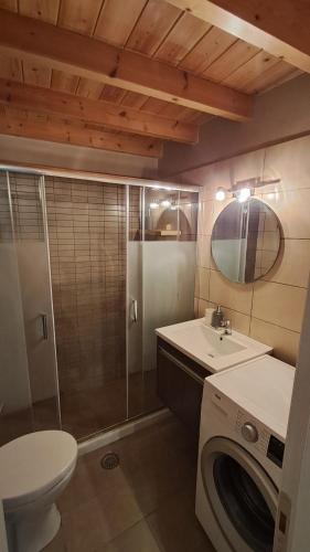 a bathroom with a sink and a washing machine at Alina's House in Arachova