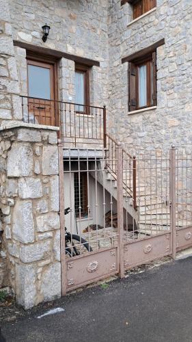 a stone building with a staircase on the side of it at Alina's House in Arachova