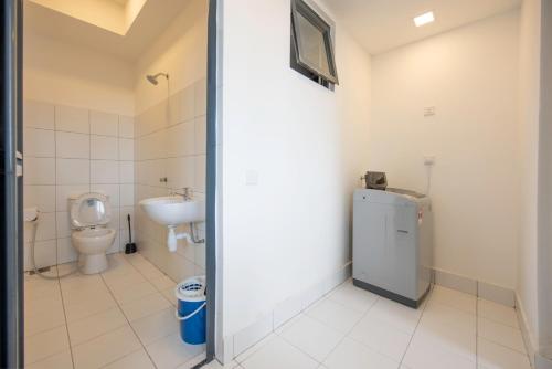 a bathroom with a toilet and a sink at The Landmark Seaview Suite in Tanjong Tokong