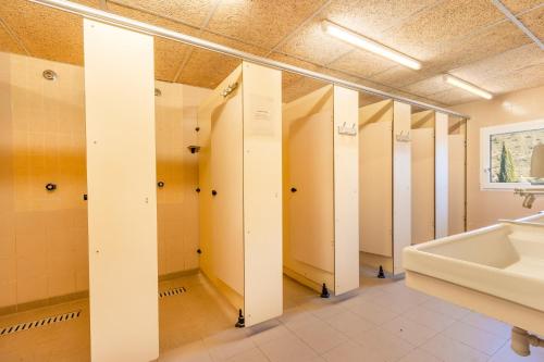 a bathroom with white stalls and a sink at Rectoria de Claverol in Claverol