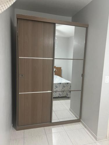 a sliding glass door in a room with a bedroom at Apartamento Beira Mar! in Capão da Canoa