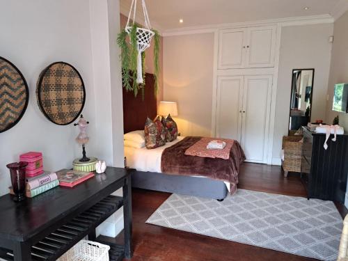 a bedroom with a bed and a piano at Taunton Manor in Pietermaritzburg