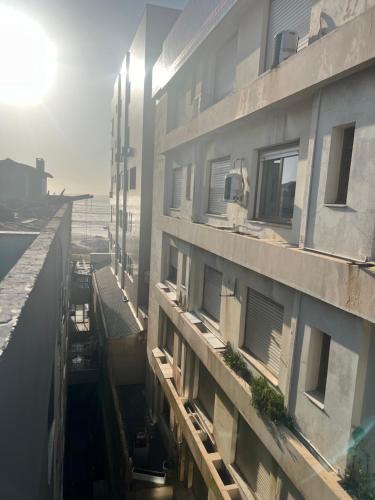 a view of an apartment building with the sun behind it at Apartamento Beira Mar! in Capão da Canoa