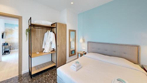 a bedroom with a bed and a mirror at Maritime Suites in Hersonissos