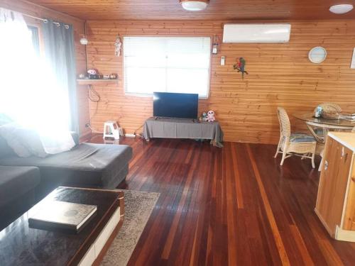 a living room with a couch and a table at Stunning Holiday Home in Dunwich Stradbroke Island in Dunwich