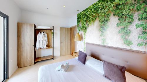 a room with a bed with a plant on the wall at Maritime Suites in Hersonissos