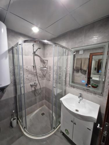 a bathroom with a shower and a sink at Villa Popovi in Simitli