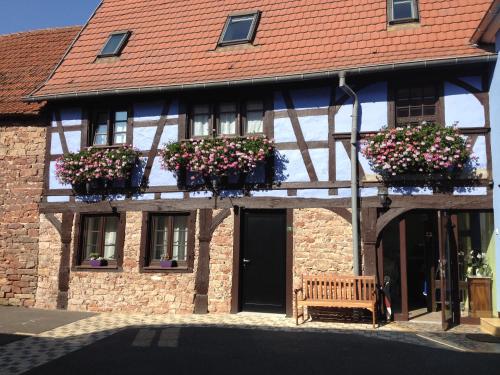 a building with flower boxes on the front of it at Les Chambres du Marlenberg in Marlenheim