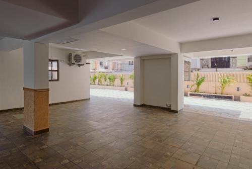 a large room with a tile floor and white walls at Brisa by StayALYF in Candolim