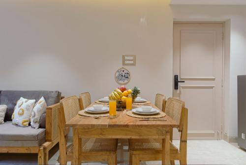 a dining room table and chairs with fruit on it at Brisa by StayALYF in Candolim