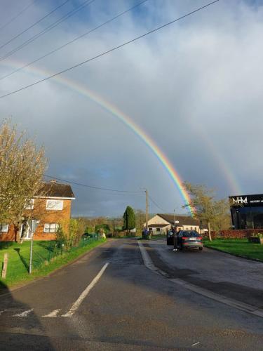 a rainbow in the middle of a street at La Cour de Grandmenil in Manhay