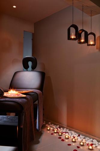 a room with a chair with candles on the floor at The Gardens Gallery Hotel in Xylokastron