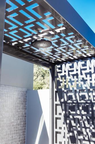 a patio with a black and white patterned ceiling at Netanya Noosa Beachfront Resort in Noosa Heads