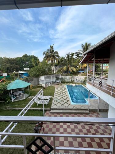 a view of the backyard of a house with a swimming pool at Villa Wistaria- Luxury 7BHK Villa With Private Pool in Alibaug