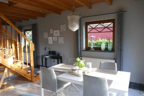 a dining room with a table and chairs and a window at Quartier 10 HA10 in Sögel