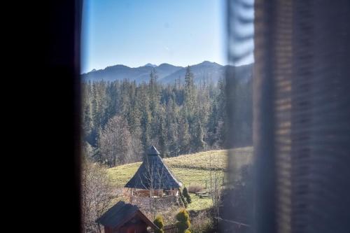 a view from a window of a house with a mountain at Marysieńka Pokoje Hrube Wyżne 12A in Zakopane