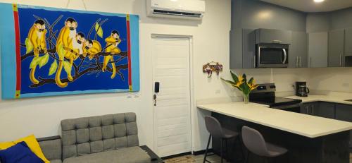 a kitchen with a painting of cats on the wall at Villa Elenita - Pura Vida in Parrita