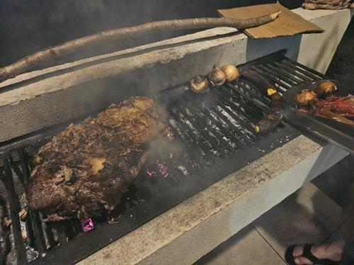 a piece of meat on a grill with other foods at Villa Elenita - Pura Vida in Parrita