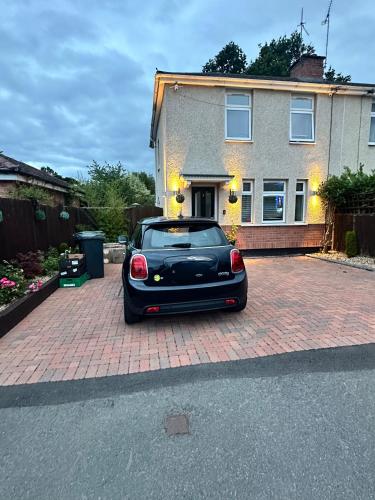 a black car parked in front of a house at Room to Rent in Worcester