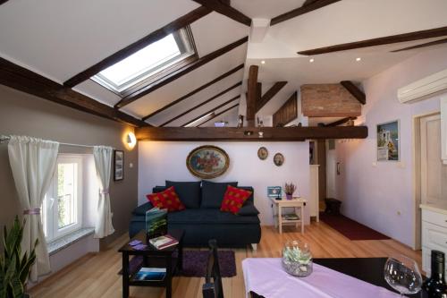 a living room with a blue couch and a skylight at Ferienwohnung in Opatija mit Klimaanlage, W-LAN, Waschmaschine 905-2 in Opatija