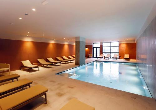 a large swimming pool in a hotel room at Montebelo Viseu Congress Hotel & Spa in Viseu