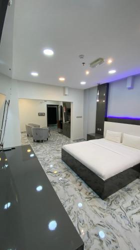 a bedroom with a large bed and a projection screen at Marina in Sohar