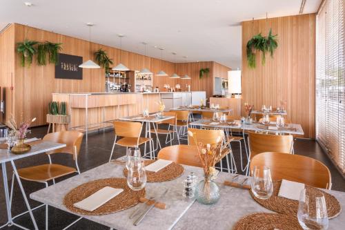 a restaurant with tables and chairs and a counter at Melia Palma Bay in Palma de Mallorca
