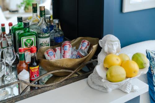 a table with bottles of alcohol and a bowl of lemons at Last Word Franschhoek in Franschhoek