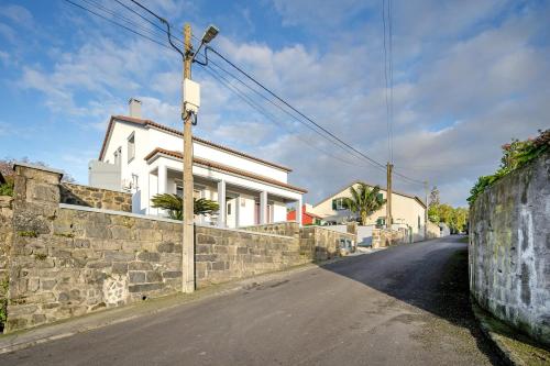 a street with a stone wall and a house at Cantinho do Sossego in Várzea