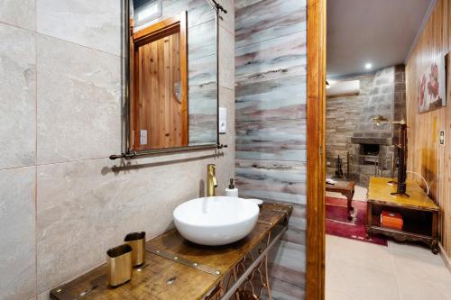a bathroom with a white sink on a wooden counter at Cantinho do Sossego in Várzea