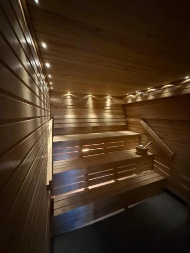 a wooden sauna with lights on the side of it at Greek house in Salo