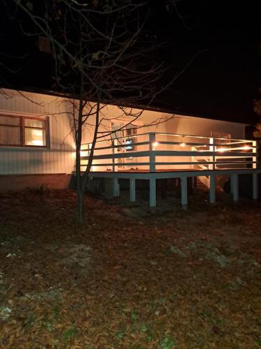 a bench in front of a building at night at Górska Otulina in Wilkowisko