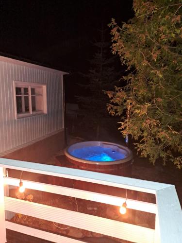 a pool on the back of a porch at night at Górska Otulina in Wilkowisko