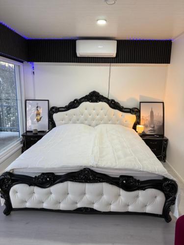 a black and white bedroom with a white bed at Greek house in Salo