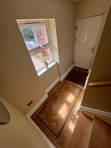 an attic room with a window and a wooden floor at Sanabria Dublin in Dublin