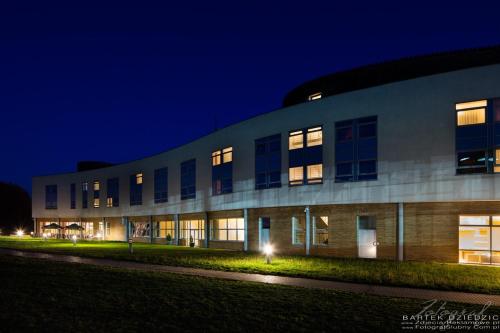 a building at night with its lights on at Hotel Victor Pruszków DeSilva in Pruszków