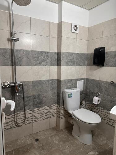 a bathroom with a toilet and a shower at Hotel Oppium Restaurant & Garden in Ruse