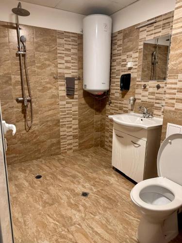 a bathroom with a toilet and a sink and a shower at Hotel Oppium Restaurant & Garden in Ruse