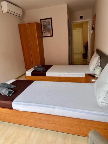 a pair of beds in a room with a mirror at Hotel Oppium Restaurant & Garden in Ruse