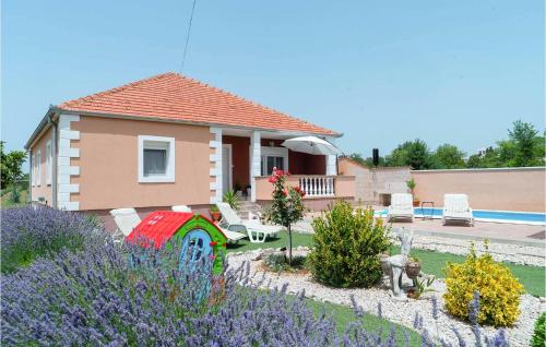 a house with a garden with purple flowers at Lovely Home In Benkovac With Wifi in Benkovac
