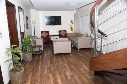 a living room with a couch and chairs at Rockville House managed & operated by Serai Boutique Hotels and Resorts in Islamabad
