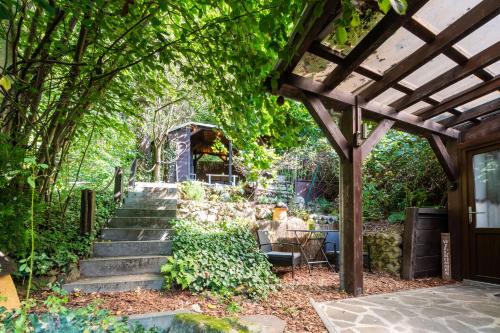a garden with stairs and a pergola at Haus am Wald in Bad Schandau