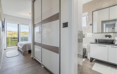 a bathroom with a shower and a sink and a tub at Nice Home In Labin With Sauna in Labin