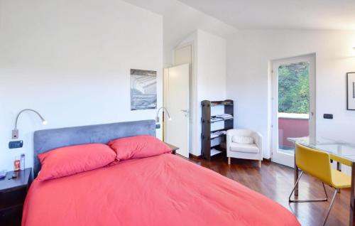 a bedroom with a red bed with a desk and a chair at 3 Bedroom Nice Home In Ne in Ne