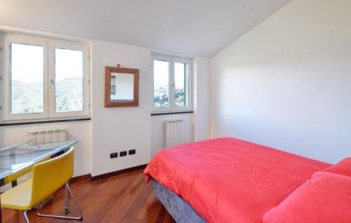 a bedroom with a bed and a desk and windows at 3 Bedroom Nice Home In Ne in Ne