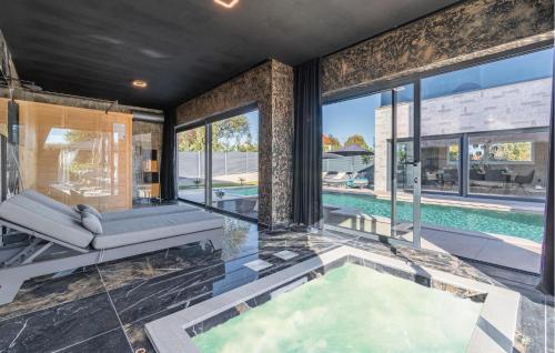 an indoor pool in a house with a swimming pool at Cozy Home In Labin With Sauna in Labin